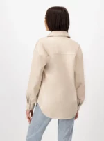 Mujer usando camisola color beige.